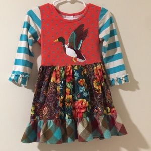 Ricrack& Ruffles dress with a duck on the front